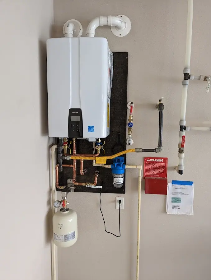 Professional plumber installing copper piping in a Solvay home